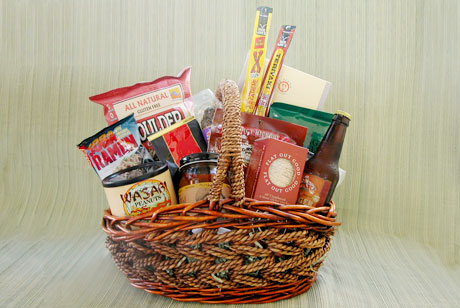 The Bachelor's Basket is full of tasty read-to-eat snacks and easy-to-cook packaged foods like beef and turkey jerky, chips & salsa, peanuts, pretzels, sausage, crackers, ramen noodles, ravioli and marinara sauce, with a ginger beer thrown in for fun.