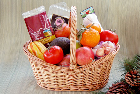 The Organic Garden contains a cornucopia of fresh, healthy fruits and vegetables. This one is loaded with a bounty of organic vine-ripened tomatoes, limes, apples mandarins, squash, pot-pourri onions, garlic, dates and an avocado.