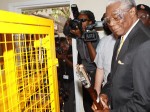 Minister of National Security, Dr. Bernard "BJ" Nottage watches intently as law enforcement and national security officials were given a demonstration on the operation of the Hydraulic Shears used for firearm destruction. (BIS Photo/Patrick Hanna)